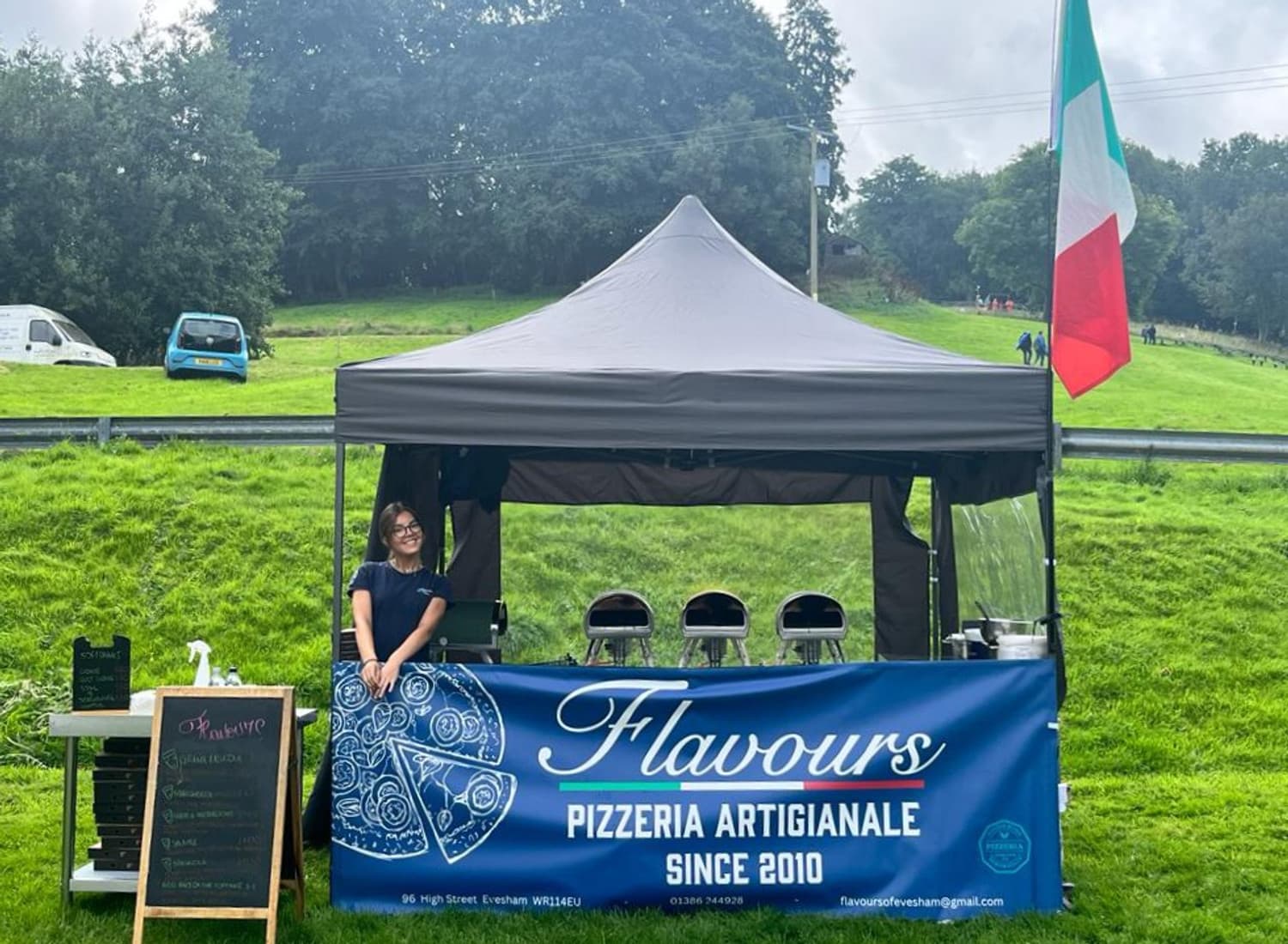 Flavours Pizzeria Artigianale gazebo at an Italian-flag-draped event