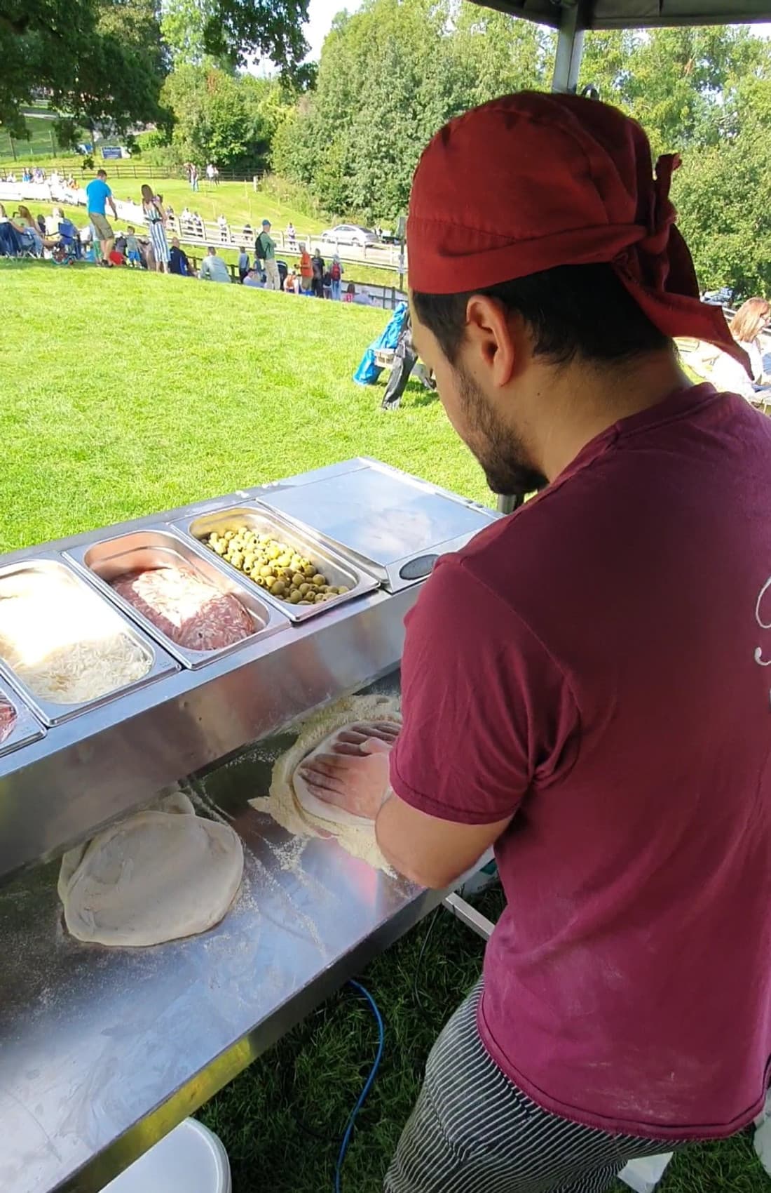 The pizzaiolo making pizza dough at an outdoor festival